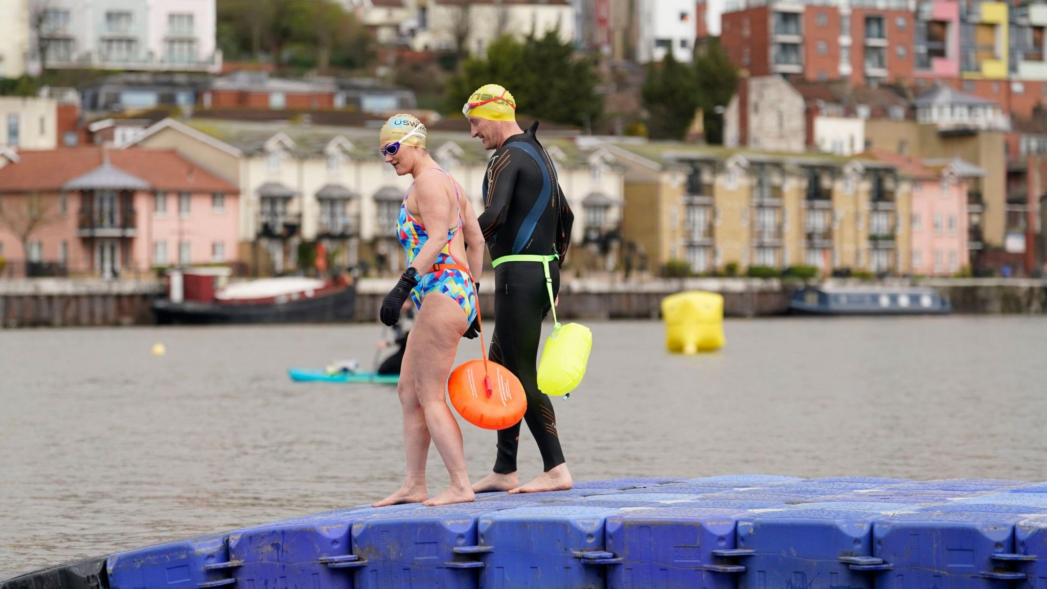 Swimmers David (right) and Karen Quartermain enter the water as they take part in the Bristol Harbour swim pilot trial on a temporary course in Baltic Wharf in Bristol