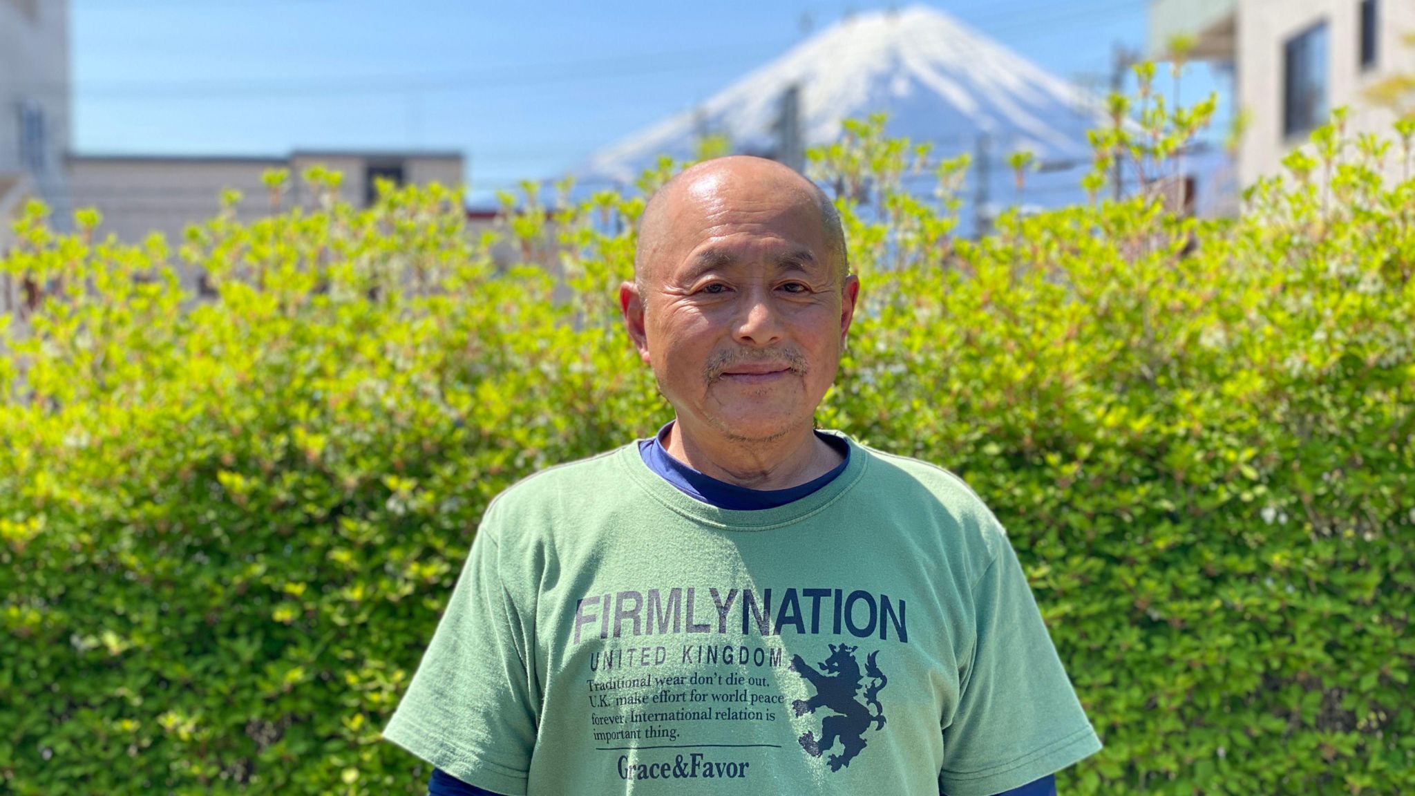 Kazuhiko Iwama, 65-year-old local, stands in front of camera