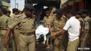 Police carry the body of a wounded colleague in Chhattisgarh in June