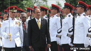 President Benigno Aquino of the Philippines inspects troops in Singapore