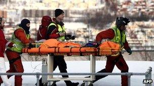 Rescuers bring a survivor to Tromso's hospital