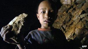 Boy holding piece of gold ore