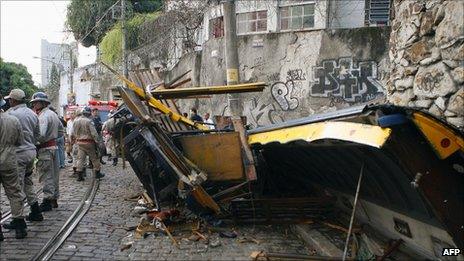 Firefighters survey the wreckage of a tram in Rio on 27 August 2011