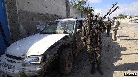 Somali government soldiers patrols the scene of an explosion in capital Mogadishu on 12 September 2012