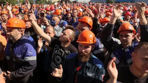 Reuters Employees of Grodno Azot company gather near a plant management office during a meeting to protest against presidential election results and to demand re-election in Grodno, Belarus August 14, 2020