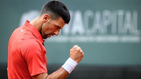 Novak Djokovic holds up his fist to celebrate
