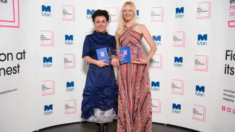 Press Association Olga Tokarczuk, left, stands with translator Jennifer Croft holding copies of Flights and the prize at the award ceremony on 22 May 2018