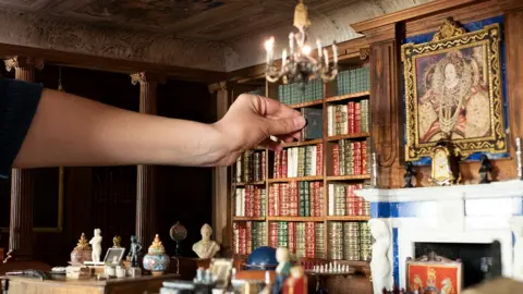 © His Majesty King Charles III 2024/PA Books being added to the Dolls' House Library.