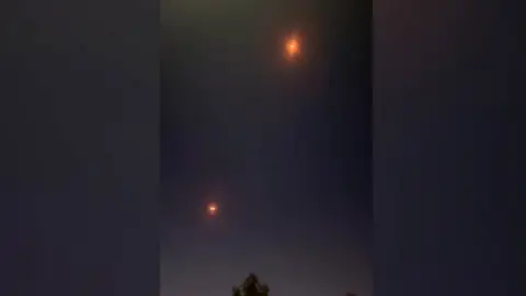 Explosions light up sky