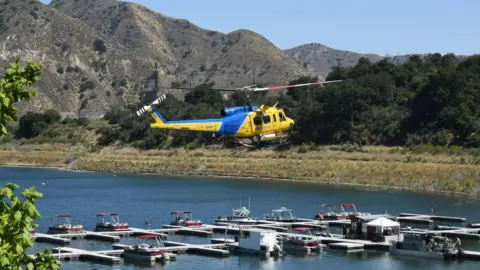 Getty Images A Ventura County Sheriff's helicopter returns to base as amid the search