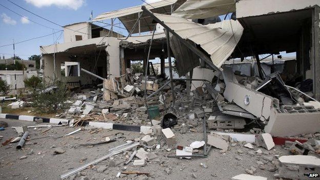 A building in Beit Hanoun, in northern Gaza, takes a hit from an Israeli air strike, 17 July