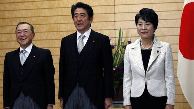 Japan's Prime Minister Shinzo Abe (C) poses for the media with new Economy, Trade and Industry Minister Yoichi Miyazawa (L) and new Justice Minister Yoko Kamikawa at Abe's official residence in Tokyo, Japan, 21 October 2014