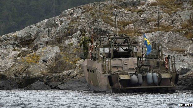 An assault vehicle lands an search team on an island in Stockholm's archipelago