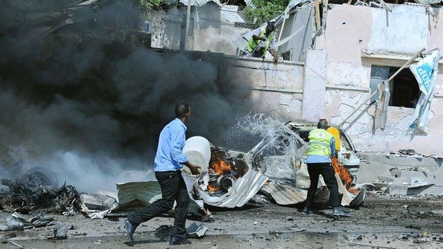 Somali security forces rush to the site of a blast near the heavily fortified gates of the airport in Mogadishu on 3 December 2014