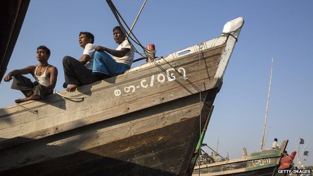 Rohingya fishermen relax on a fishing boat on a boat jetty in March 2015 near the Burmese town of Sittwe