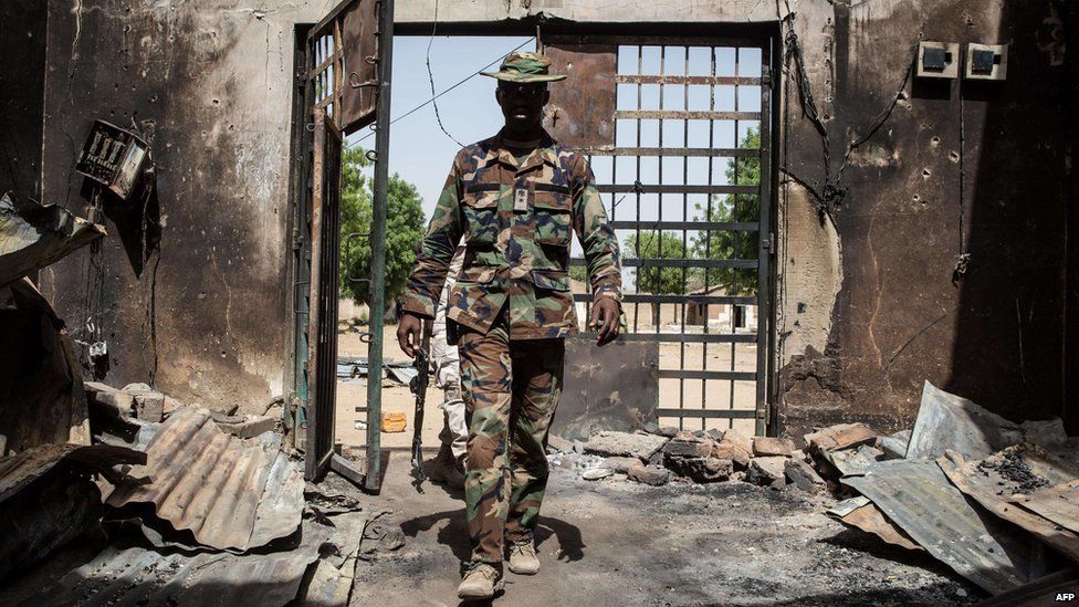 A Nigerian soldier arrives to inspect the former prison of Bama on 25 March 2015