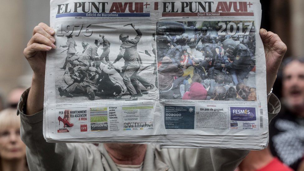 A man holds up a newspaper showing images of police violence during protest in Barcelona against the violence that marred a referendum. 2 October, 2017 in Barcelona