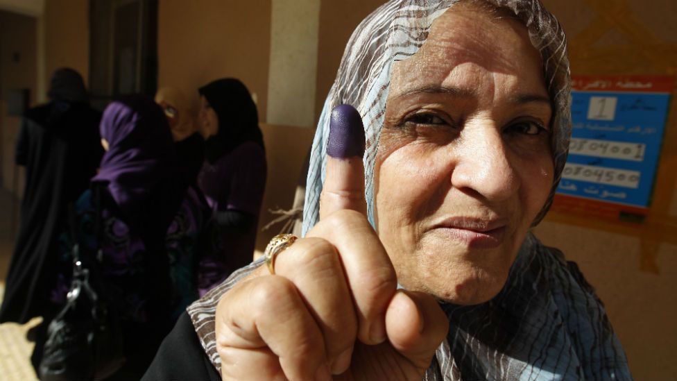 A Libyan woman shows her ink-stained finger after voting at a previous election in the eastern city of Benghazi.