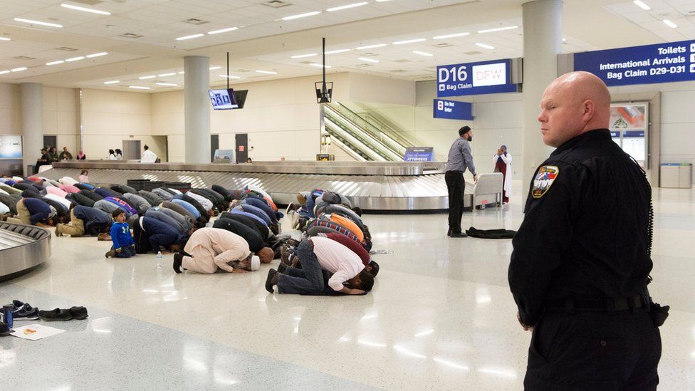 People gather to pray in baggage claim during a protest against the travel ban imposed by U.S. President Donald Trump's executive order, at Dallas/Fort Worth International Airport in Dallas, Texas, U.S. on January 29, 2017