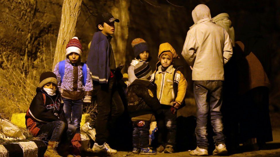 Syrian children waiting on the outskirts of the besieged rebel-held Syrian town of Madaya