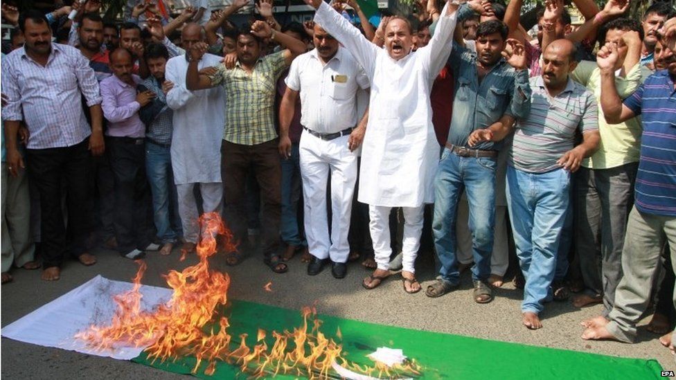 Activists of Hindu hardline origination Shiv Sena shout anti-Pakistani slogans as they burn a Pakistani flag during a protest against an attack on Indian Army camp at Uri, in Jammu, India,