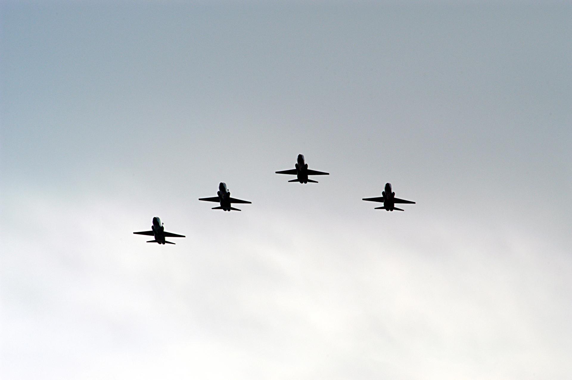 4 T-38 jets fly in formation where a 5th jet appears to be missing