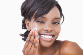 Woman of color using skin cream