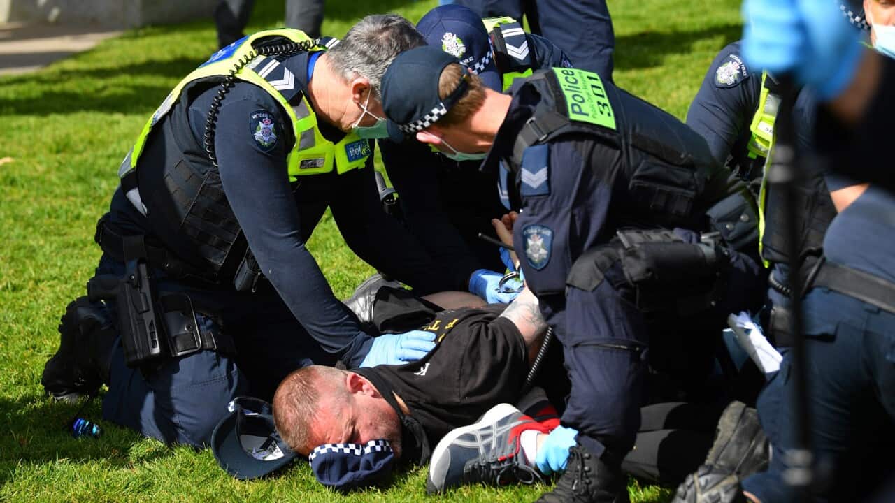A protester is arrested by Victorian Police Officers outside of the Shrine of Remembrance in Melbourne.
