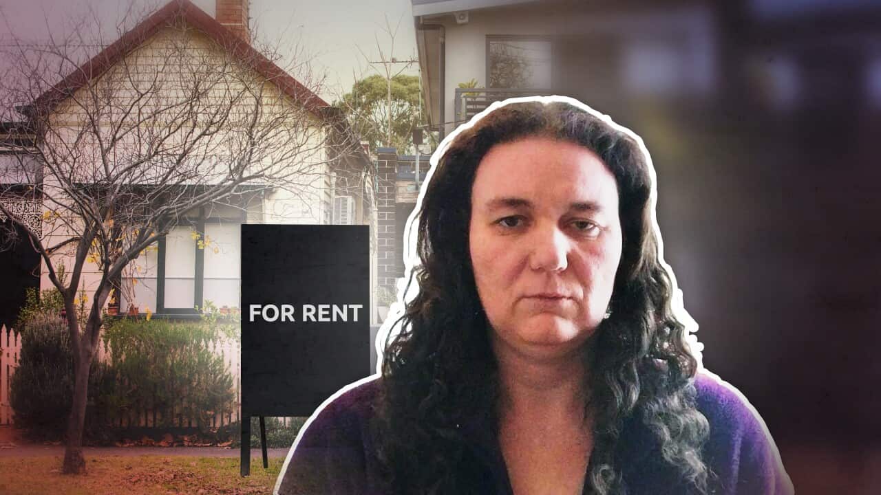 A woman with long brown hair wearing a purple top. in the background are houses with a 'for rent' sign in front of one of them