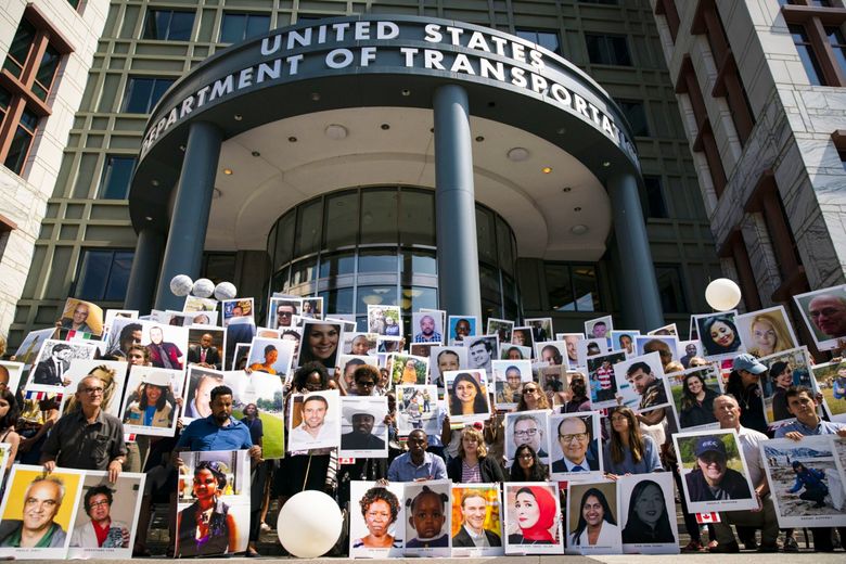 Family members of victims from the Ethiopian Airlines Flight 302 crash hold photographs during a vigil outside the Department of Transportation in Washington, D.C.,, on Sept., 10, 2019. Two crashes within five months — Lion Air Flight 610 in October 2018 off the coast of Indonesia and Ethiopian Airlines Flight 302 in March outside Addis Ababa — killed 346 people and led to a global grounding of Boeing’s 737 MAX jets. The Justice Department is expected to meet on May 31 with families of those killed to inform them of its decision on whether Boeing met the conditions of a deferred prosecution agreement. (Al Drago / Bloomberg)