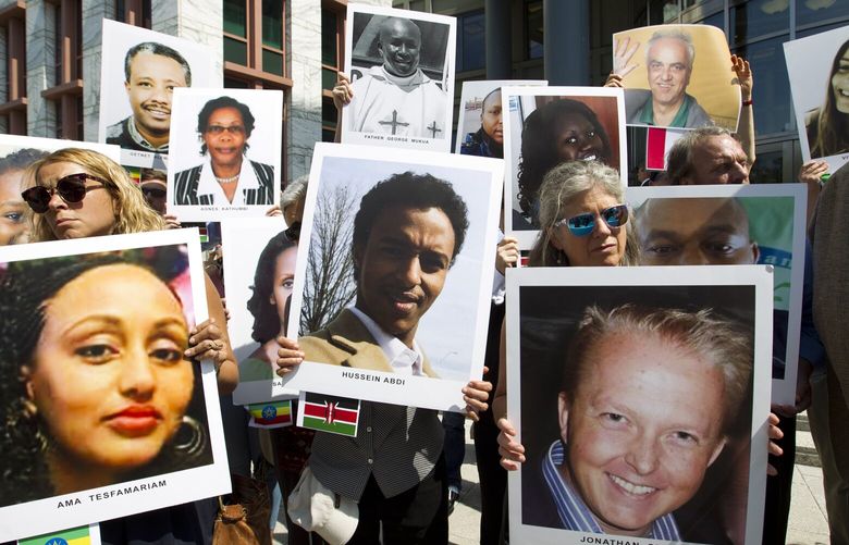 Demonstrators hold pictures of plane crash victims during a vigil on the six-month anniversary of the crash of a Boeing 737 Max 8, killing 157 people in Ethiopia on March 10, which has resulted in the grounding hundreds of the planes worldwide, outside of the Department of Transportation, Tuesday, Sept. 10, 2019 in Washington. (AP Photo/Jose Luis Magana)