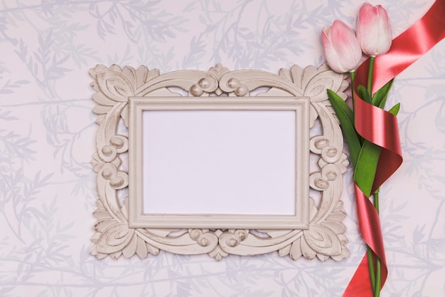 Free photo above view arrangement with tulips and frame