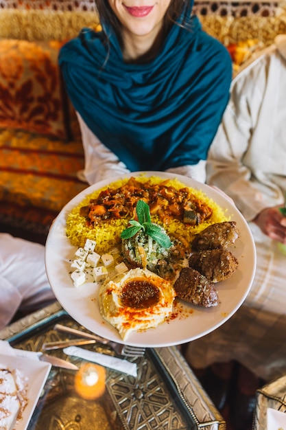 Woman and arab dish in restaurant