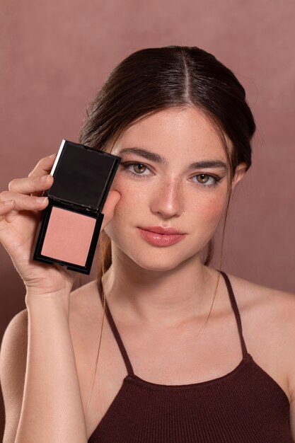 Beautiful young woman portrait with a make-up product