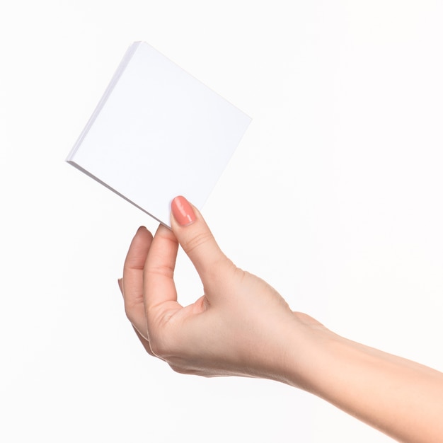 Free photo female hand holding blank paper for records on white with right shadow