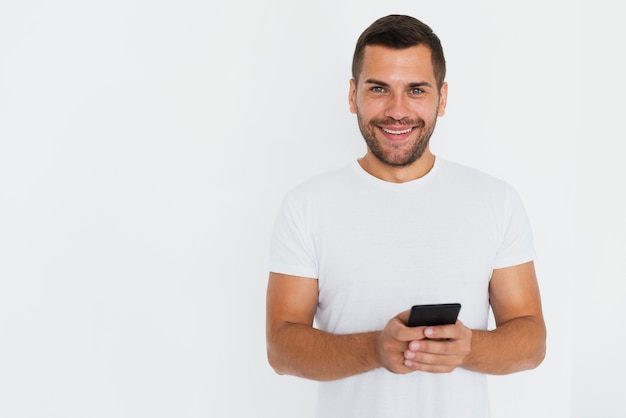 Man having his phone in hands and white background