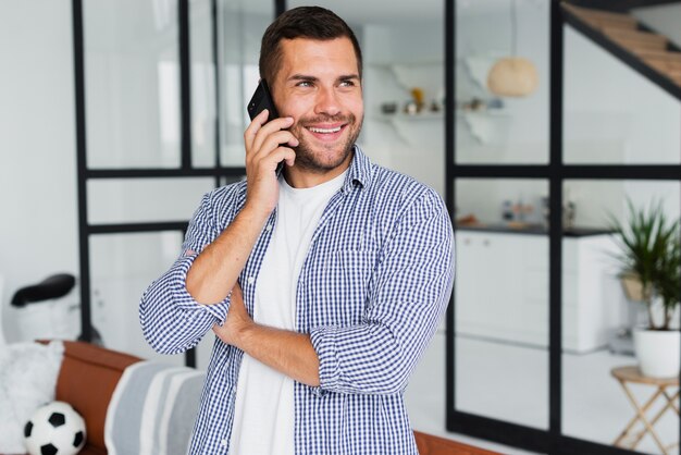 Man talking on the phone and looking away while being happy