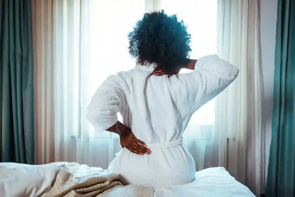 photo of woman waking up with back pain