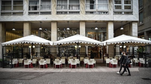An empty restaurant in Milan, where close to 2,000 infections were recorded over the last 24 hours