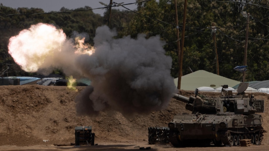 Fire flashes from the canon of a tank