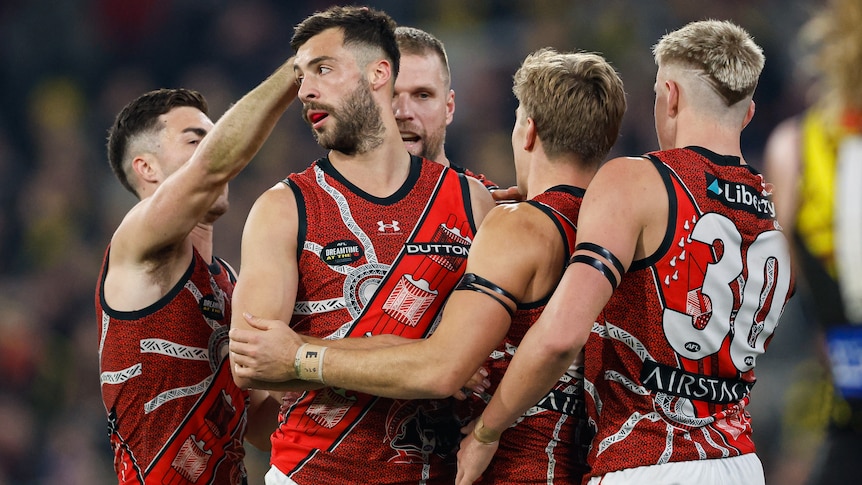 Essendon players celebrate a goal from Kyle Langford