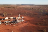 An aerial photo of a desert patch with mining equipment