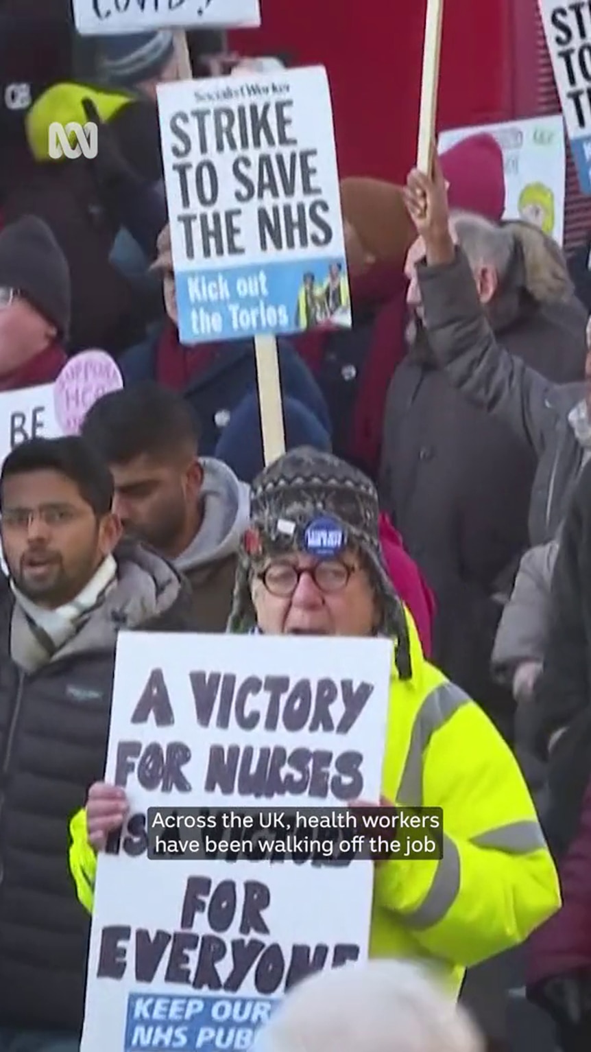 People hold placards with text such as: "strike to save the NHS" "A victory for nurses..."