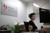 Woman looking at a computer at an office