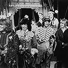 Eric Clapton, Marianne Faithfull, Brian Jones, Bill Wyman, and The Rolling Stones in The Rolling Stones Rock and Roll Circus (1996)