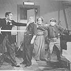 Moe Howard, Larry Fine, Gino Corrado, and Curly Howard in Micro-Phonies (1945)