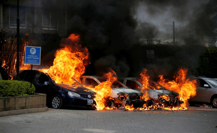 Image: Cars are seen on fire at the scene where explosions and gunshots were heard at the Dusit hotel compound, in Nairobi