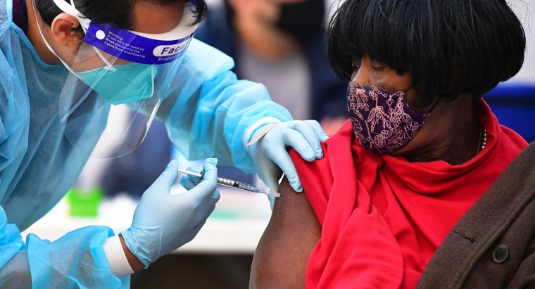 Image: Nurse administers the Moderna Covid-19 vaccine to woman in Los Angeles