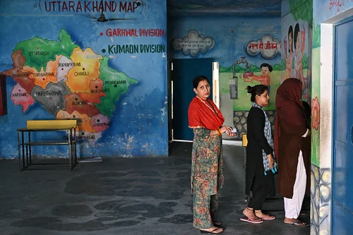 (Photo by ARUN SANKAR via Getty Images) : Voters wait in queue at a polling station to cast their ballot during the first phase of voting of Indias general elections in Haridwar, Uttarakhand state, on April 19, 2024. 
