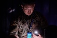 U.S. Army Reserve Sgt. 1st Class Dong Lim, a linguist assigned to 373rd Military Intelligence Battalion, 259th Expeditionary Military Intelligence Brigade, Military Intelligence Readiness Command, searches for evidence in the dark during the site exploitation station at the 2024 Polyglot Games. The Utah National Guard’s 300th Military Intelligence Brigade (Linguist) hosted the 6th annual Best Linguist Competition (Polyglot Games) Feb. 3, 2024 in Salt Lake City, Utah that brought together over 200 linguists from nearly 80 different units. (U.S. Army Reserve photo by Maj. Joshua Frye)